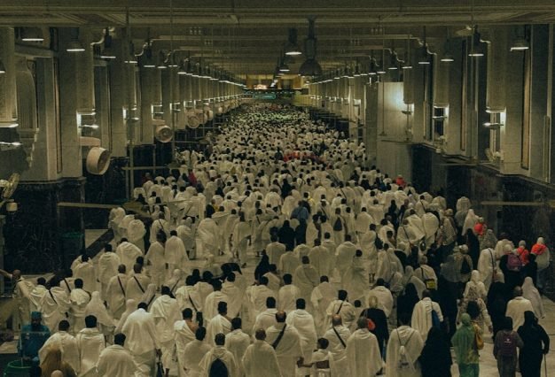 A large group of people walking down a hallway