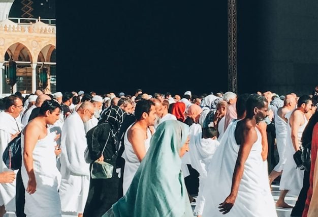 a group of people walking around a large building